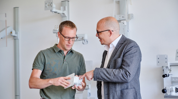 Employee shows customer a part of a product