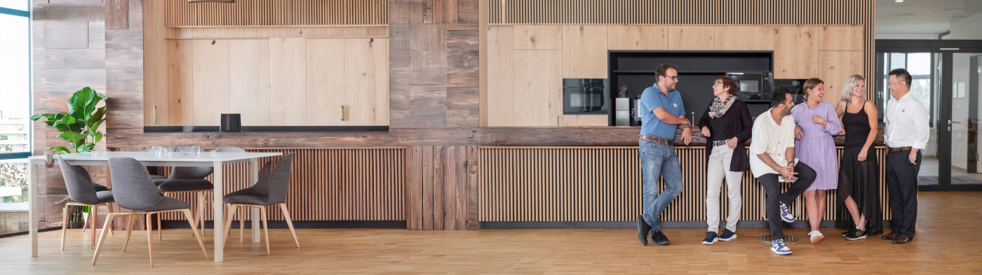 A diverse group of people smiling and talking